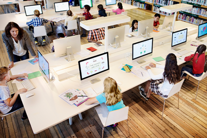 Schüler:innen sitzen in einem Computerraum an den Computern.